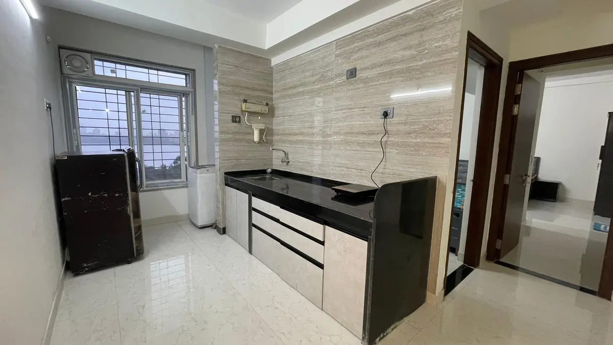 Shared kitchen with induction cooktop and refrigerator